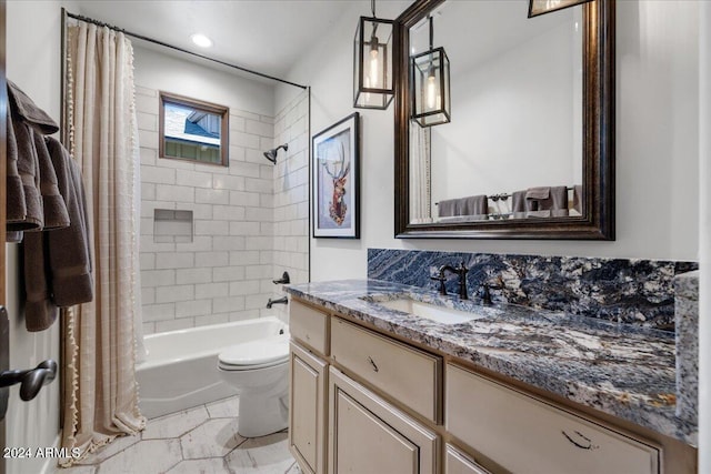full bath with shower / tub combo, toilet, and vanity