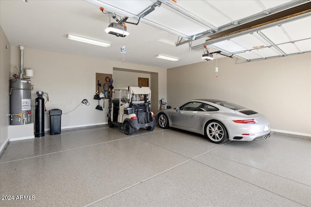 garage featuring water heater, a garage door opener, and baseboards