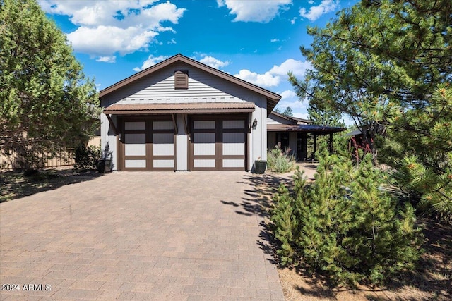 view of front of house with decorative driveway and a garage