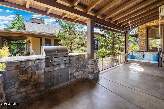 view of patio with area for grilling and an outdoor kitchen