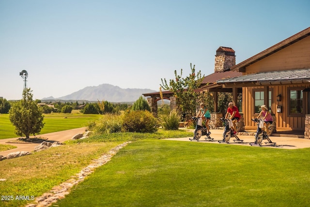 view of yard with a mountain view and a patio