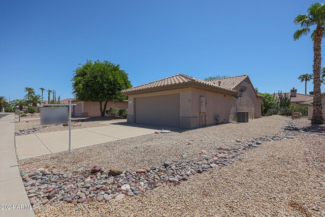 view of front of house featuring central AC and a garage