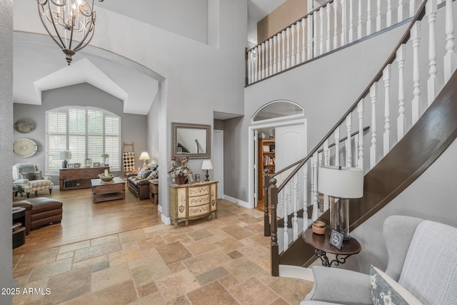 9708 E Pampa Ave, Mesa, AZ 85212 - entrance foyer with a high ceiling, stairs, stone tile flooring, a chandelier, and baseboards