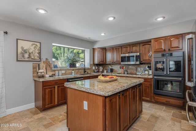 9708 E Pampa Ave, Mesa, AZ 85212 - kitchen with stainless steel microwave, multiple ovens, tasteful backsplash, light stone counters, and stone tile flooring