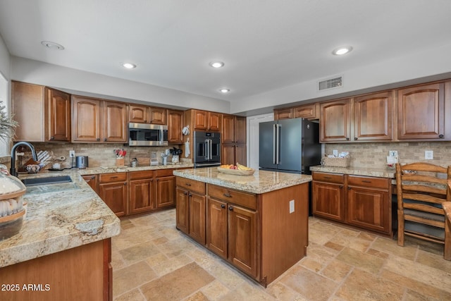 9708 E Pampa Ave, Mesa, AZ 85212 - kitchen with stainless steel microwave, high end refrigerator, a sink, brown cabinets, and tasteful backsplash