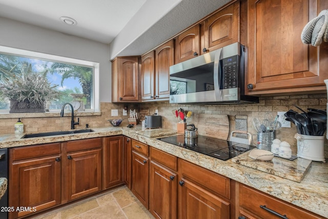 9708 E Pampa Ave, Mesa, AZ 85212 - kitchen with black appliances, a sink, backsplash, and brown cabinetry