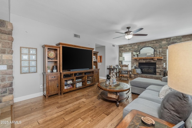 9708 E Pampa Ave, Mesa, AZ 85212 - living room with a fireplace, a ceiling fan, light wood finished floors, and baseboards