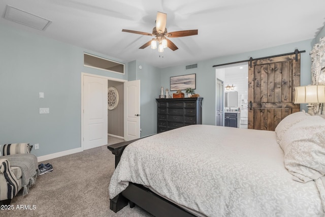 9708 E Pampa Ave, Mesa, AZ 85212 - bedroom featuring carpet floors, baseboards, a barn door, connected bathroom, and a ceiling fan