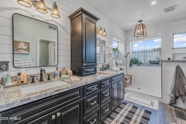9708 E Pampa Ave, Mesa, AZ 85212 - full bath featuring a walk in shower, double vanity, a chandelier, and wood finished floors