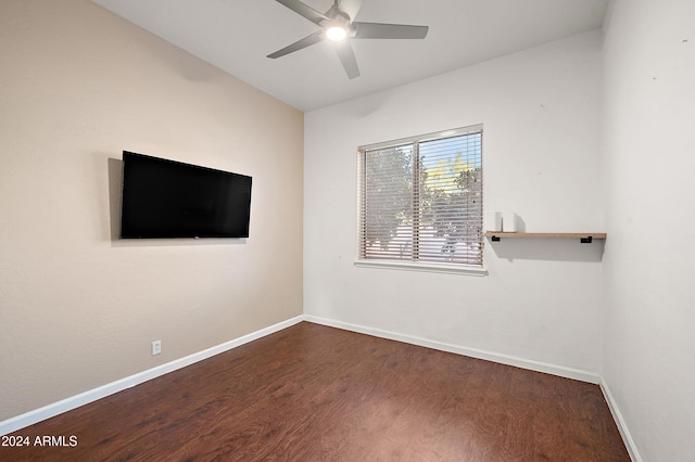 spare room with ceiling fan and dark hardwood / wood-style flooring