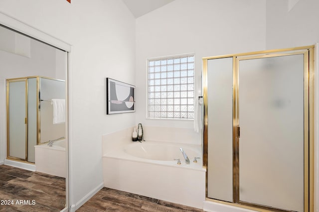 bathroom with independent shower and bath and hardwood / wood-style flooring