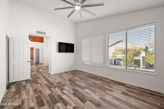 unfurnished room featuring vaulted ceiling, ceiling fan, and dark wood-type flooring