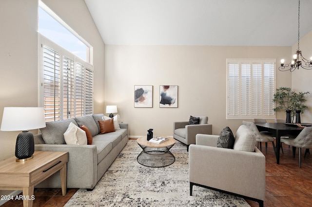 living room with tile patterned flooring, vaulted ceiling, and a notable chandelier