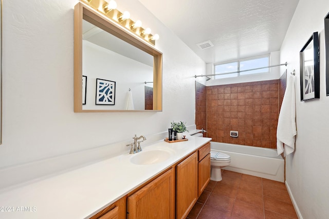 full bathroom featuring a textured ceiling, vanity, tile patterned flooring, toilet, and tiled shower / bath