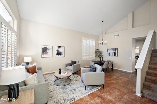 living room with an inviting chandelier and high vaulted ceiling