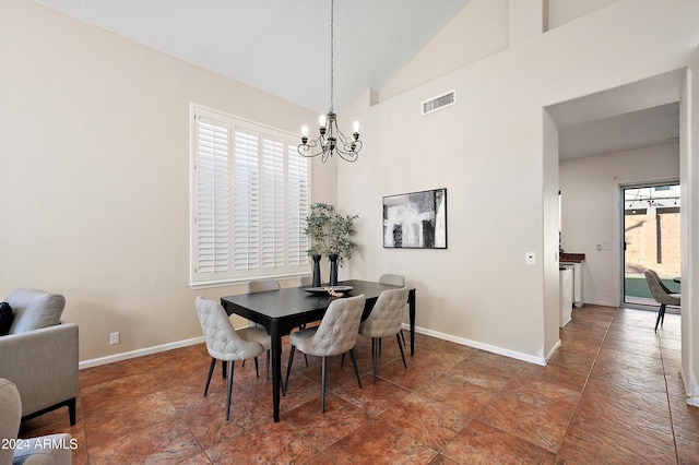 dining room with high vaulted ceiling and a notable chandelier