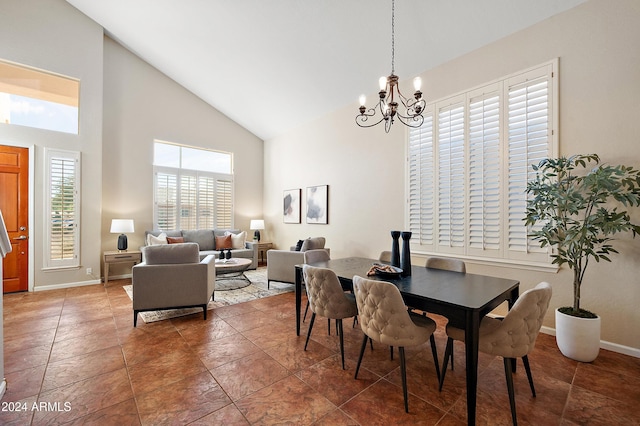 dining room with high vaulted ceiling and a chandelier