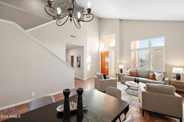 living room with an inviting chandelier and high vaulted ceiling