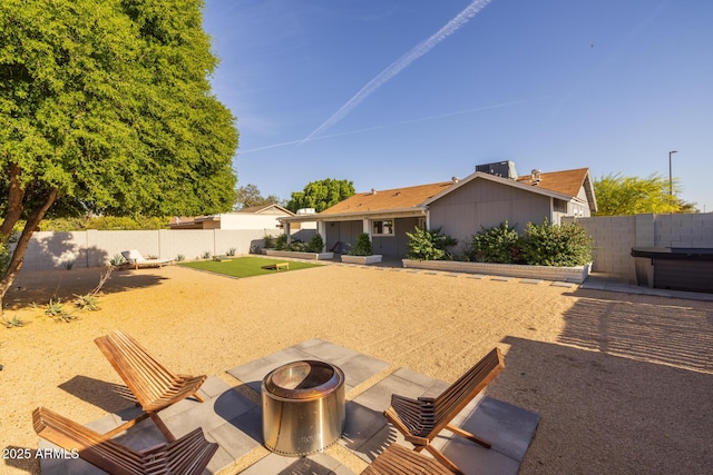view of yard with a fenced backyard, an outdoor fire pit, and a patio area