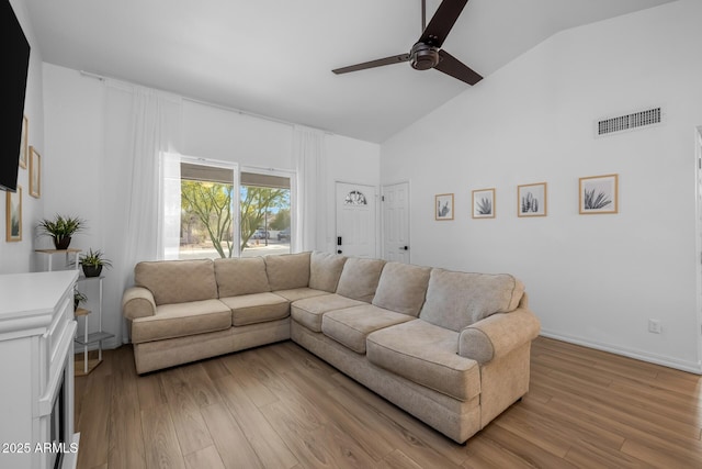 living area with a ceiling fan, high vaulted ceiling, visible vents, and light wood-type flooring