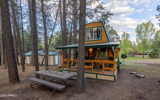 1053 Pond Cir, Forest Lakes, AZ 85931 - rear view of house featuring an outdoor structure, metal roof, and a storage unit