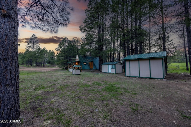 1053 Pond Cir, Forest Lakes, AZ 85931 - yard at dusk featuring an outbuilding and a shed