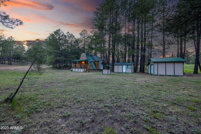 1053 Pond Cir, Forest Lakes, AZ 85931 - yard at dusk featuring an outbuilding and a storage unit