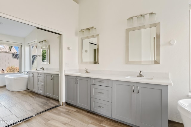 bathroom with vanity and a bath