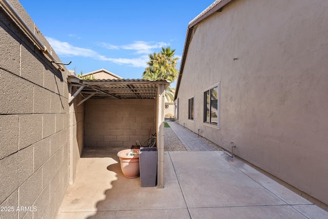 view of side of property with a patio area