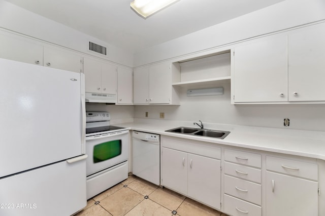 kitchen with white cabinets, sink, light tile patterned floors, and white appliances