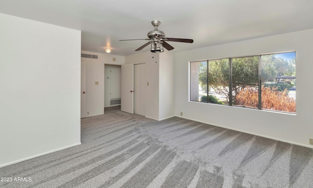 spare room with carpet and ceiling fan