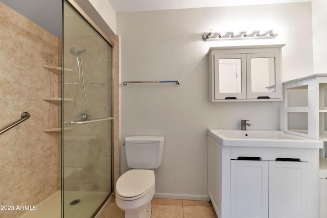 bathroom featuring vanity, toilet, tile patterned flooring, and an enclosed shower