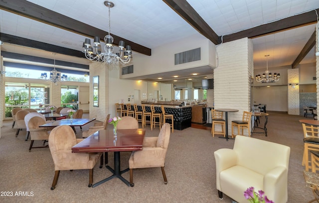 dining room with decorative columns, carpet flooring, a notable chandelier, and beamed ceiling