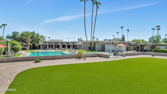 view of pool featuring a patio area and a lawn