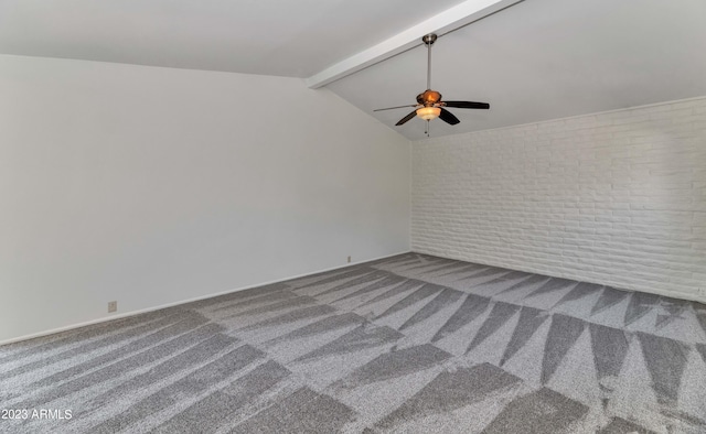 unfurnished room featuring brick wall, lofted ceiling with beams, carpet flooring, and ceiling fan