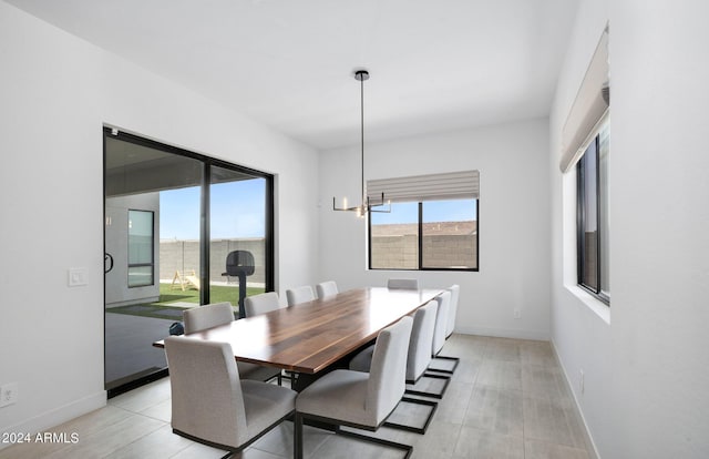 dining room with baseboards and a chandelier