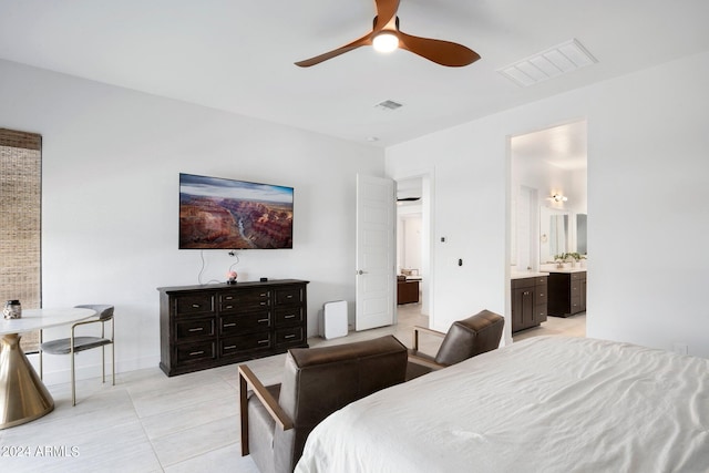 bedroom featuring a ceiling fan, visible vents, light tile patterned floors, and ensuite bathroom