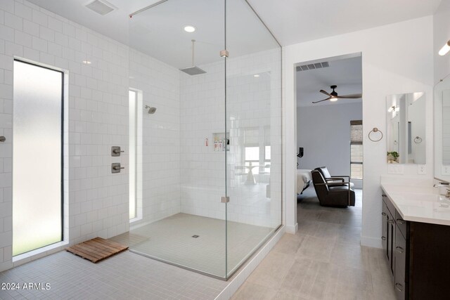 ensuite bathroom featuring visible vents, tile patterned flooring, a walk in shower, vanity, and connected bathroom