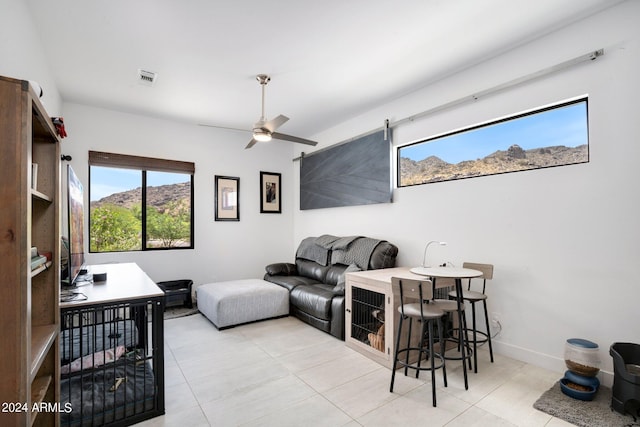 living room featuring ceiling fan and light tile patterned floors