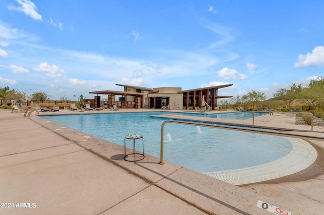 pool featuring fence and a patio area