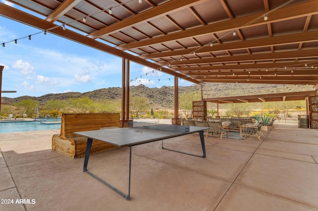 view of patio / terrace with a fenced in pool and a mountain view