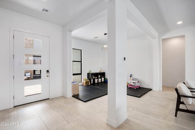 foyer featuring light tile patterned flooring, baseboards, visible vents, and recessed lighting