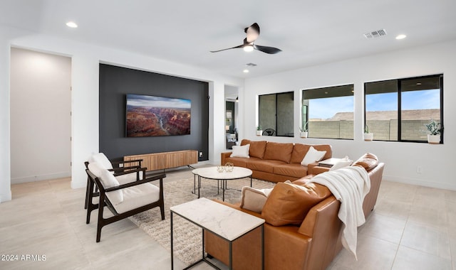 tiled living room featuring radiator heating unit and ceiling fan