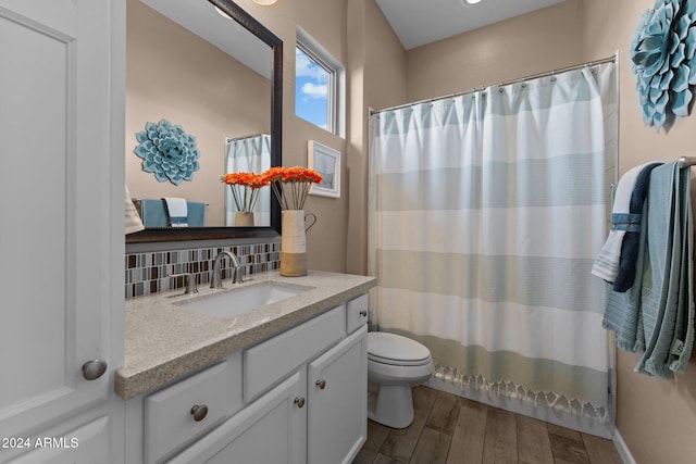 bathroom featuring toilet, tasteful backsplash, vanity, and wood-type flooring