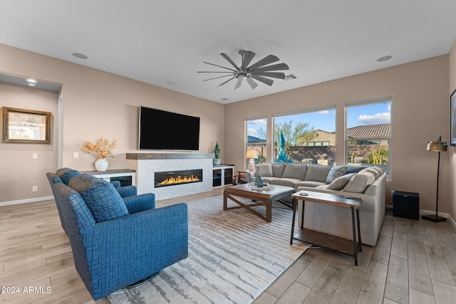 living room with light hardwood / wood-style floors and ceiling fan