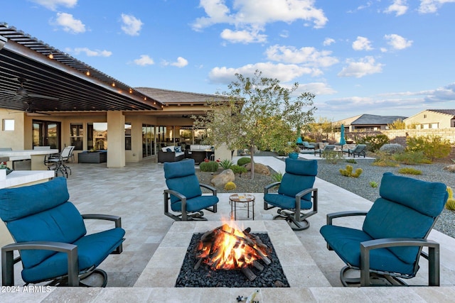 view of patio / terrace with an outdoor living space with a fire pit