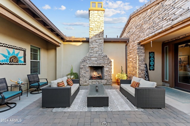 view of patio / terrace with an outdoor living space with a fireplace