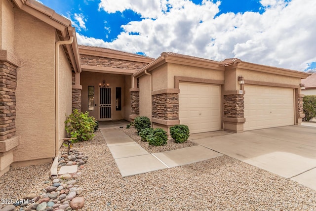 view of front of house featuring a garage, stone siding, concrete driveway, and stucco siding