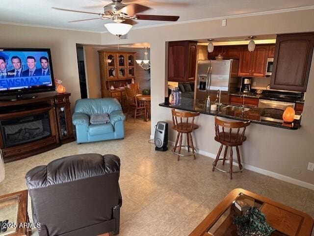 living room featuring ceiling fan, sink, and crown molding