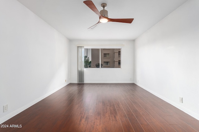 empty room featuring dark hardwood / wood-style flooring and ceiling fan